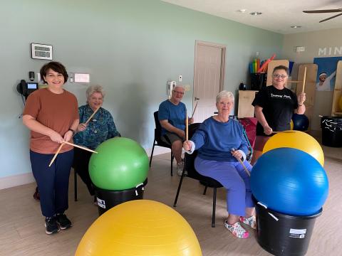 Several people are participating in a Drums Alive class. 