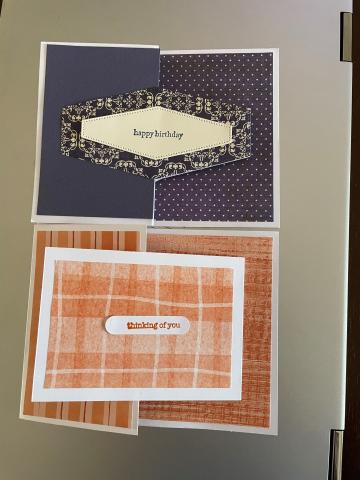 Picture of 2 greeting cards. One is in a Navy color and the other Orange.  They both have interesting folds.