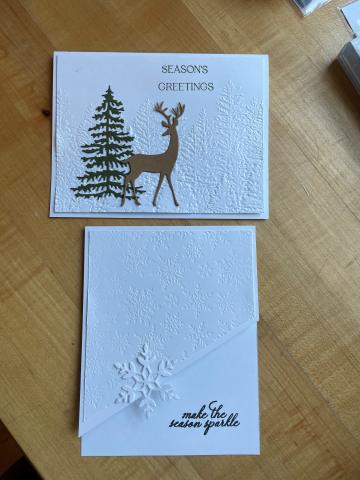 picture of 2 christmas cards one with a deer and a tree. Both with embossed backgrounds.