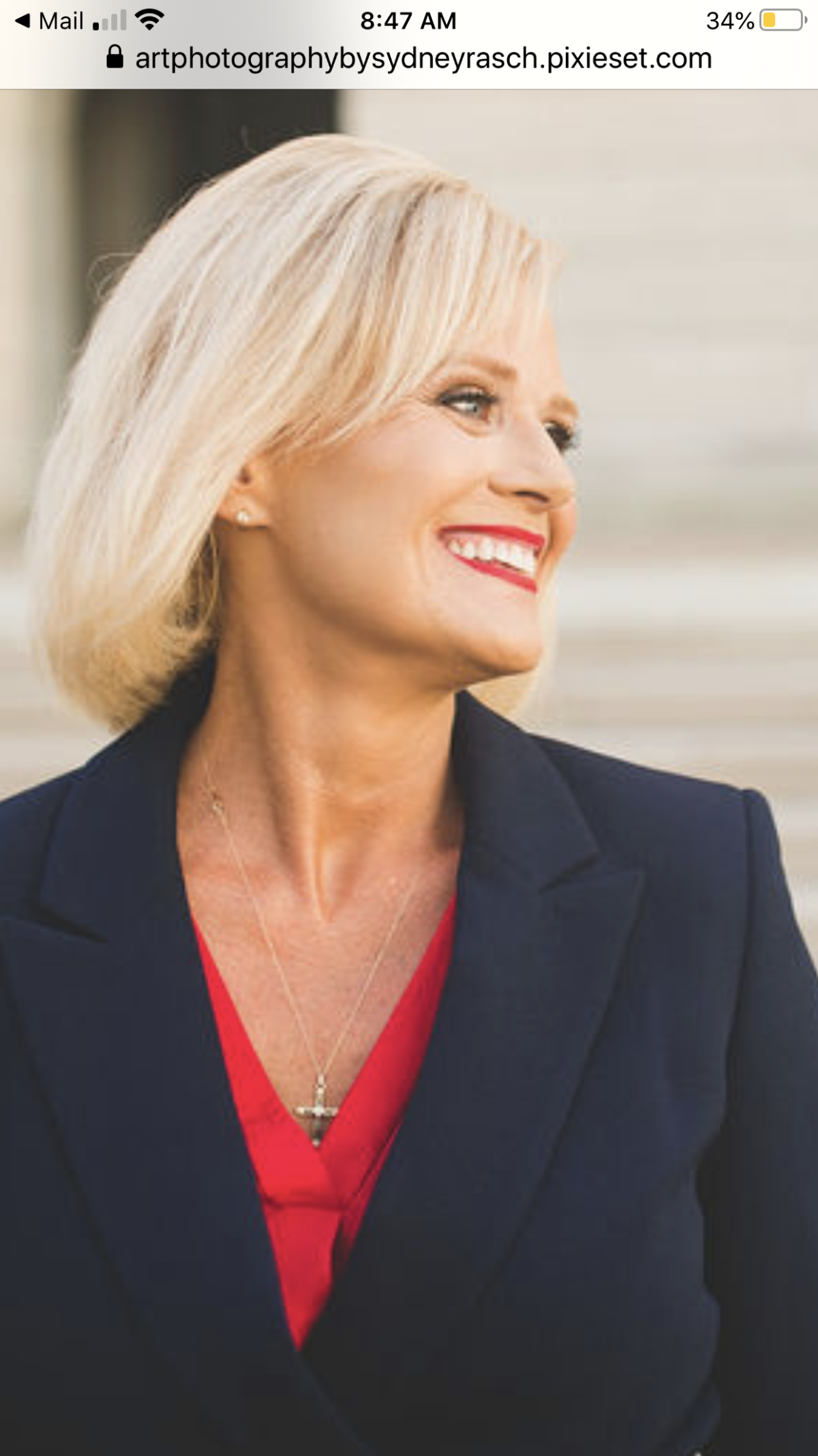 picture of smiling woman in blue and red